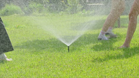 children playing in a sprinkler