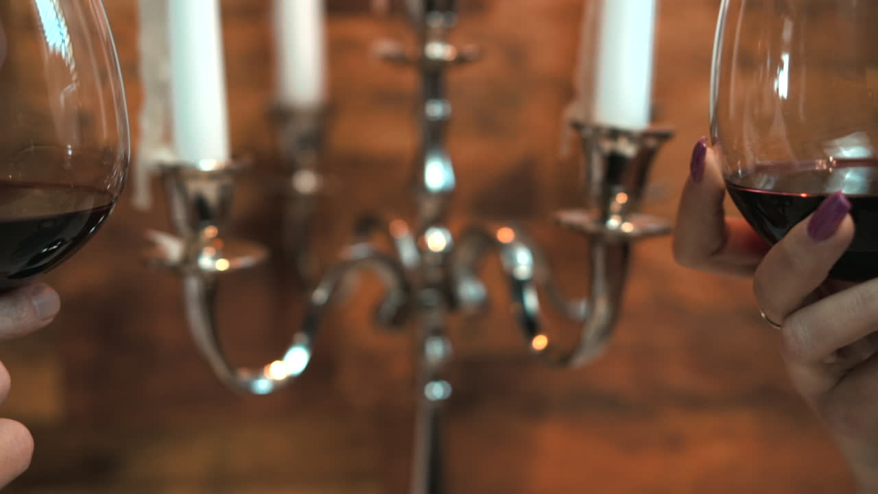 Knock on two glasses of red wine. Slow motion