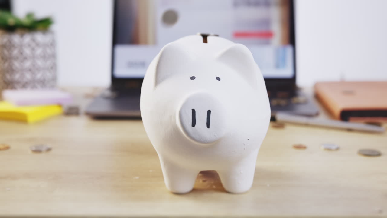 Coin, inflation and piggy bank on a table