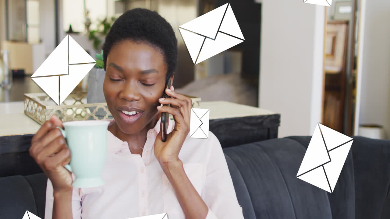 Animation of envelope icons falling over african american woman using smartphone