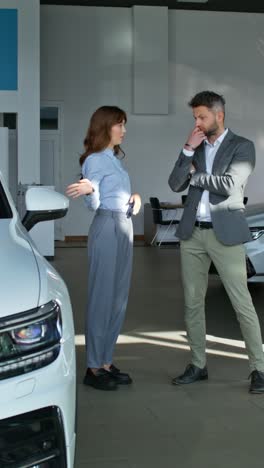 customer discussing a car purchase in a showroom