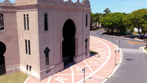 Aerial-orbit-of-the-front-area-of-the-neo-mudejar-style-Real-de-San-Carlos-bullring-in-Colonia-del-Sacramento,-Uruguay