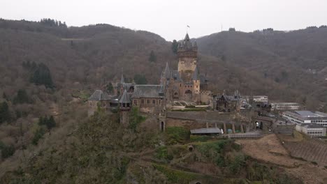 beautiful close up drone shot of the castle in cochem city next to the river moselle in germany