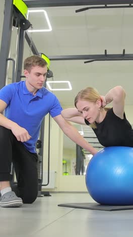 woman performing core exercise with personal trainer