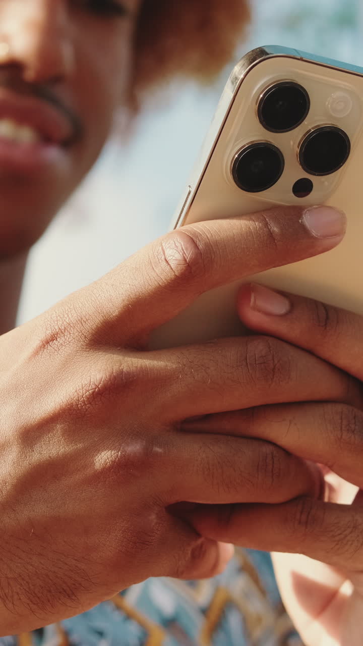 Close-up of Young Man Holding and Looking at a Smartphone