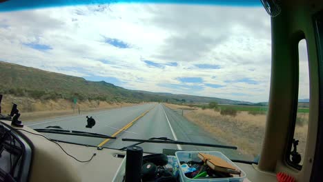 pov of the passenger while riding in a class a rv that is driving along the cliffs and okanogan river in the okanogan highlands of north central washington state