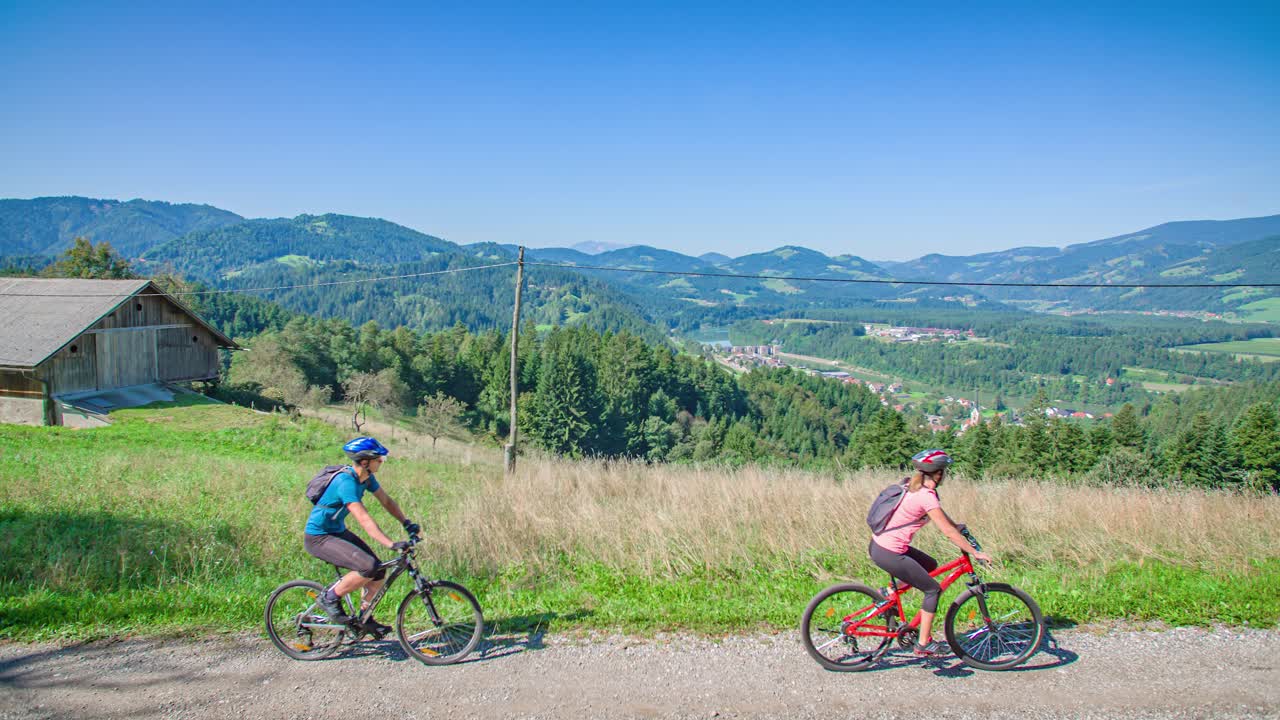 Adult caucasian couple has tour bike around Vuzenica, Slovenia, slowmo