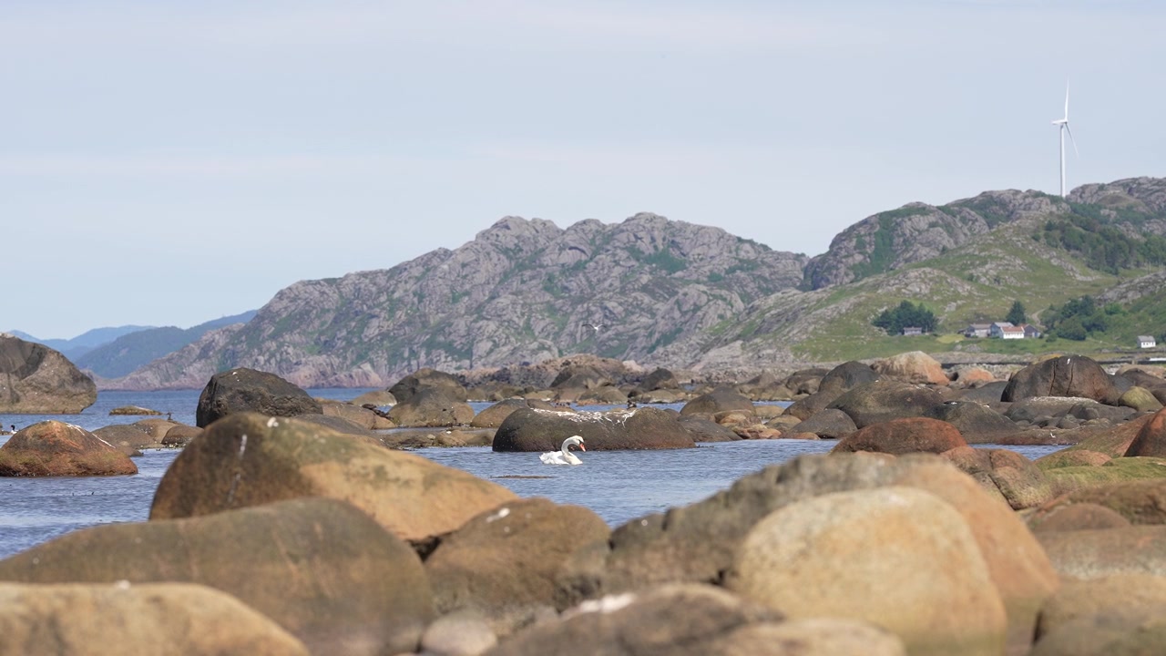 Rocky coastline with mountains at Stavstø Farsund Norway in slow motion