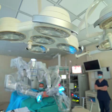 surgical room. modern surgical lamps on blur background of operation process with robotic system. medical equipment and doctors in operating theatre