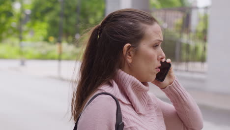 Stressed-Or-Angry-Woman-Outdoors-With-Financial-Worries-About-Cost-Of-Living-Crisis-Debt-And-Paying-Bills-Talking-On-Mobile-Phone-4