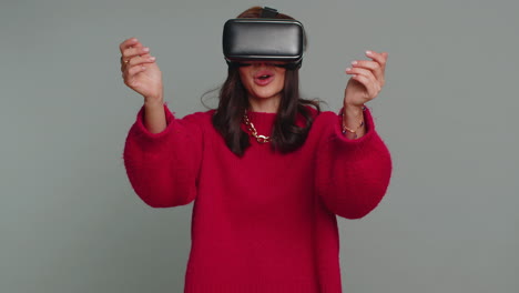 Young-woman-using-virtual-reality-headset-helmet-to-play-simulation-game-app,-watching-video-content