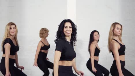 group of female dancers learning how to move their bodies when dancing bachata.