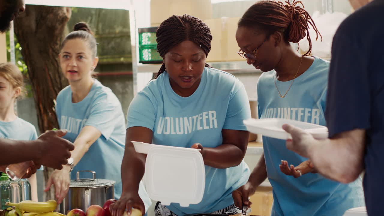 Voluntary Ladies Giving Food To Homeless