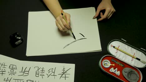 person practicing calligraphy