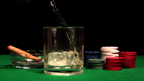 whiskey pouring into glass on casino table