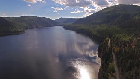 Toma-Aérea-De-Drones-En-Montana-En-Un-Lago-Con-Un-Bote-En-Otoño-O-En-Otoño