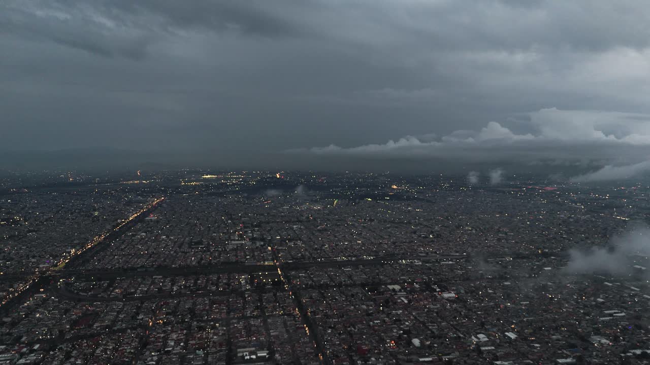 Ecatepec on a cloudy day with low clouds, seen from a drone. Nighttime