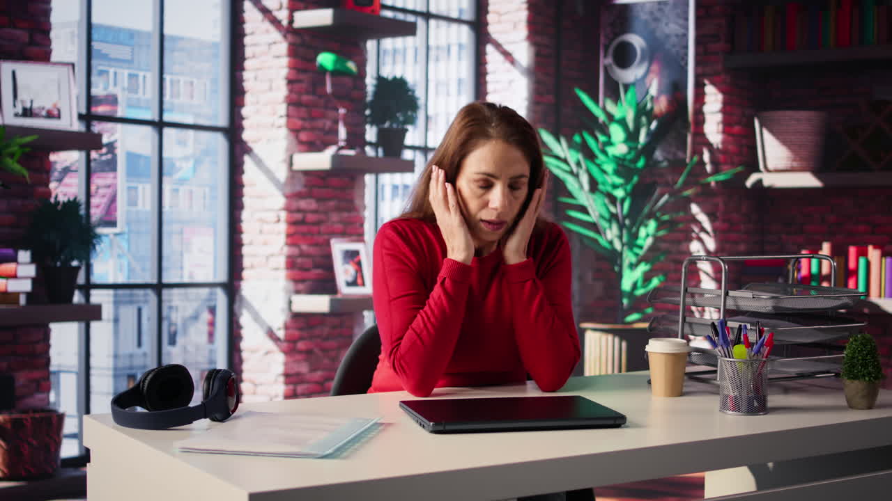 Woman working on laptop in office setting