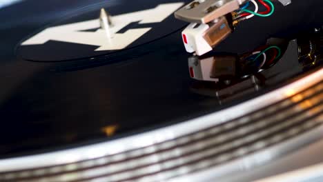 close up, modern turntable with rotating vinyl record, dj gear, equipment, a-side played