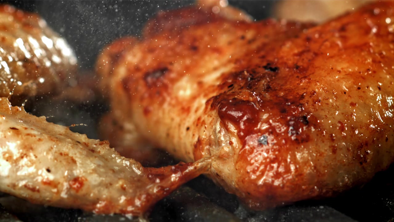 Deliziose cosce di pollo che sfrigolano su una griglia calda