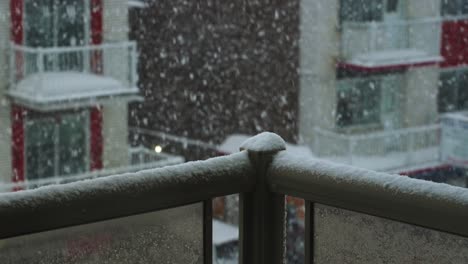 Moving-Shot-of-Balcony-Rail-Corner-during-Snow-blizzard-outside-of-window