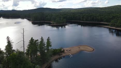 Drone-shot-of-a-remote-private-beach-with-boaters-in-the-Adirondack-State-Park-in-New-York