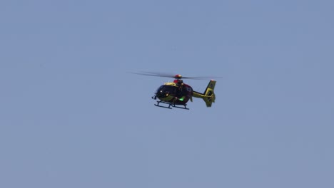 a helicopter maneuvers smoothly in a serene sky