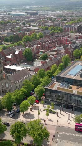 passsing overhead social ratio aerial video of queen's university, belfast on a bright and sunny day. filmed in 1080x1920, 60fps and with rec709 color