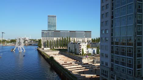 Gorgeous-aerial-top-view-flight-Molecule-Man-on-border-river-Spree,-east-Berlin-Germany-evening-summer-23