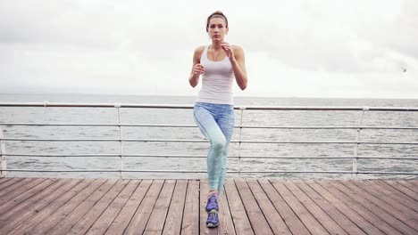 Runner-woman-stretching-legs-with-lunge-hamstring-stretch-exercise-leg-stretches.-Fitness-female-athlete-relaxing-on-beach-doing