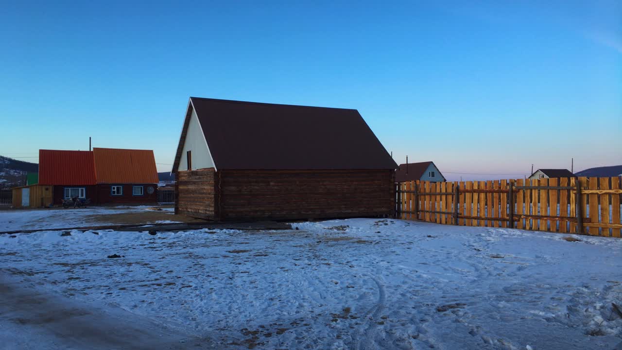 Log Cabin Houses In Khatgal, Mongolia With Snowy Yard In Winter