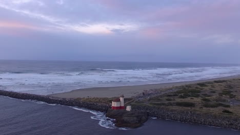 Coquille-River-lighthouse-drone-footage-taken-during-sunset,-where-Pacific-Ocean-meets-the-Oregon-coast