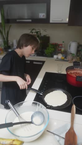 boy cooking pancakes