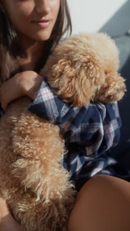 woman holding a fluffy poodle