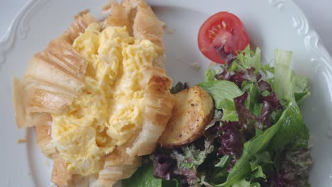 croissant with eggs and salad