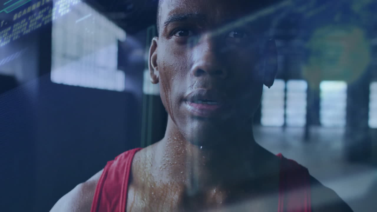 Male athlete training inside fitness gym, displaying colorful line charts and data overlays