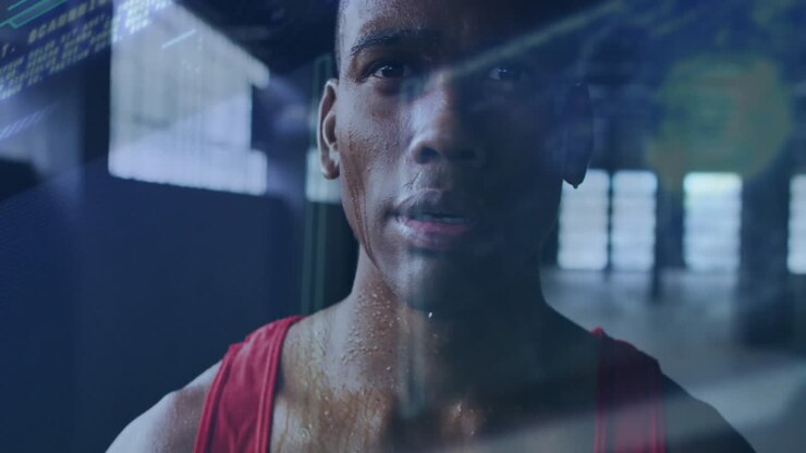 Male athlete training inside fitness gym, displaying colorful line charts and data overlays
