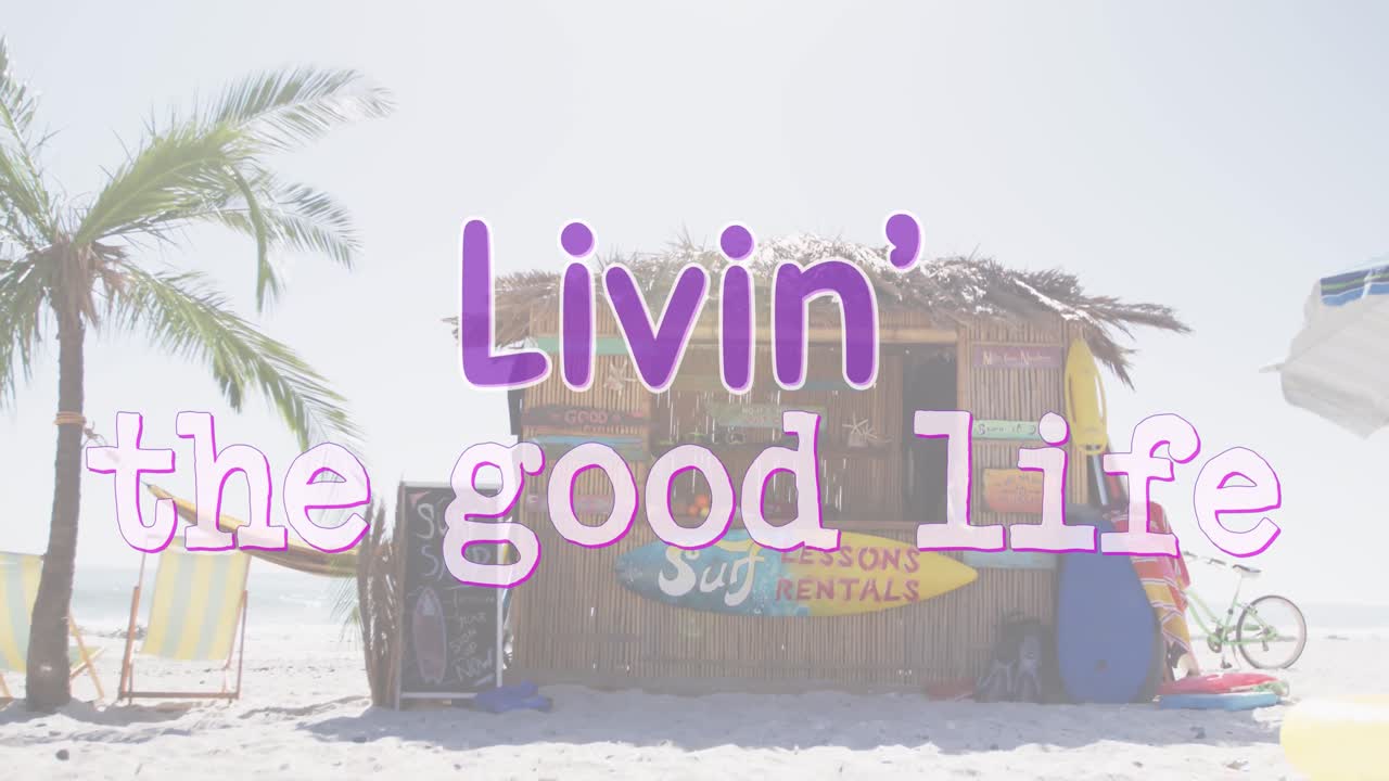 Animation of the words livin' the good life written in purple and white over beach surf rental hut