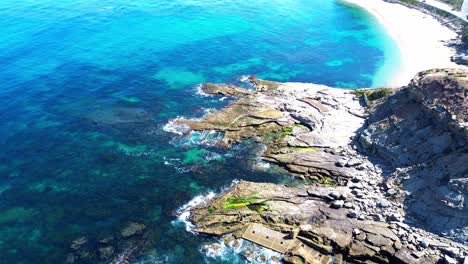 aerial-view-of-rugged-coast-,-blue-waves,-4k