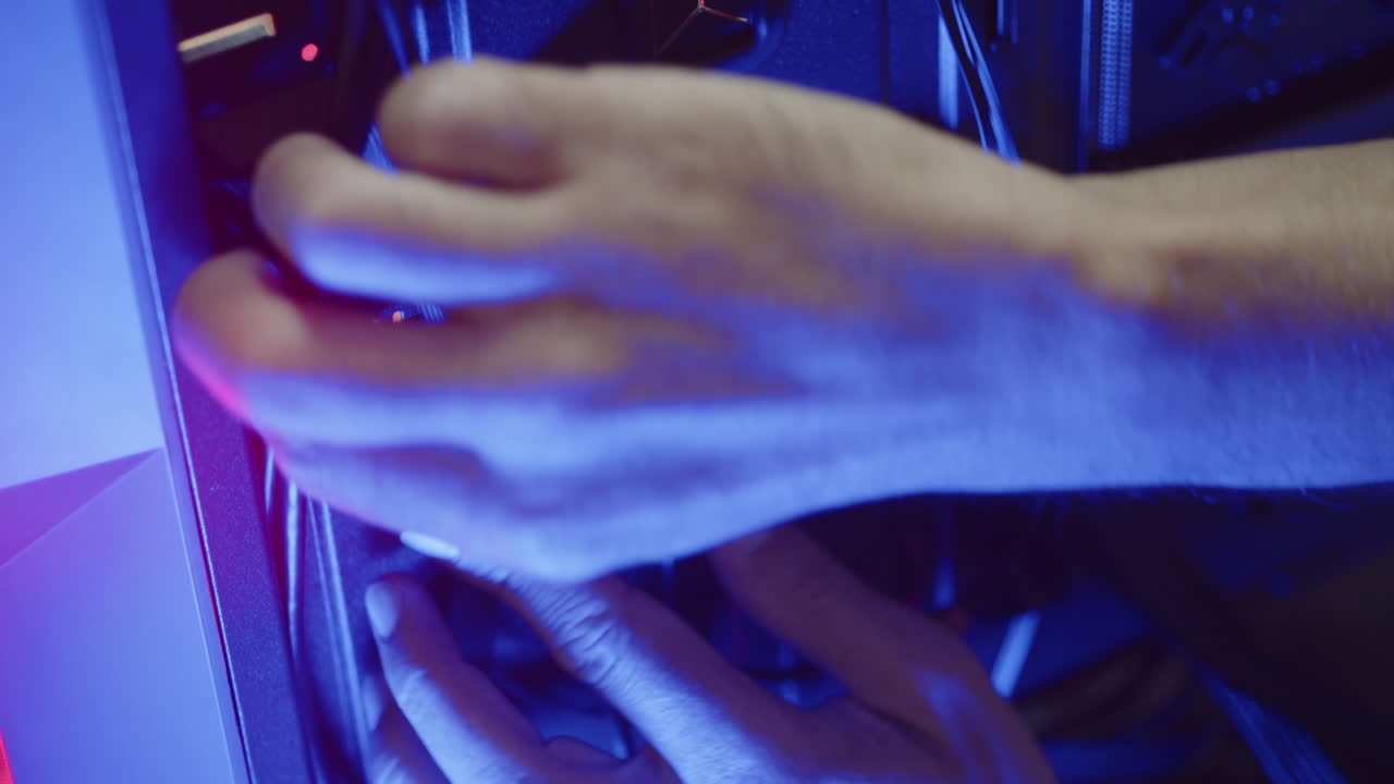 Male technician fixing calbles on a pc