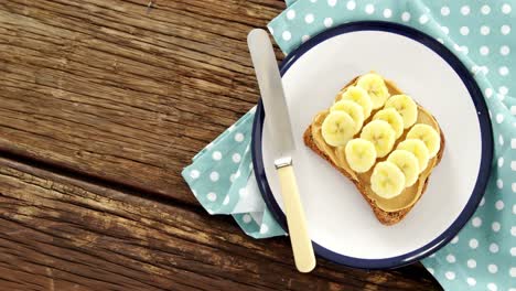 sliced bananas spread on brown bread in plate