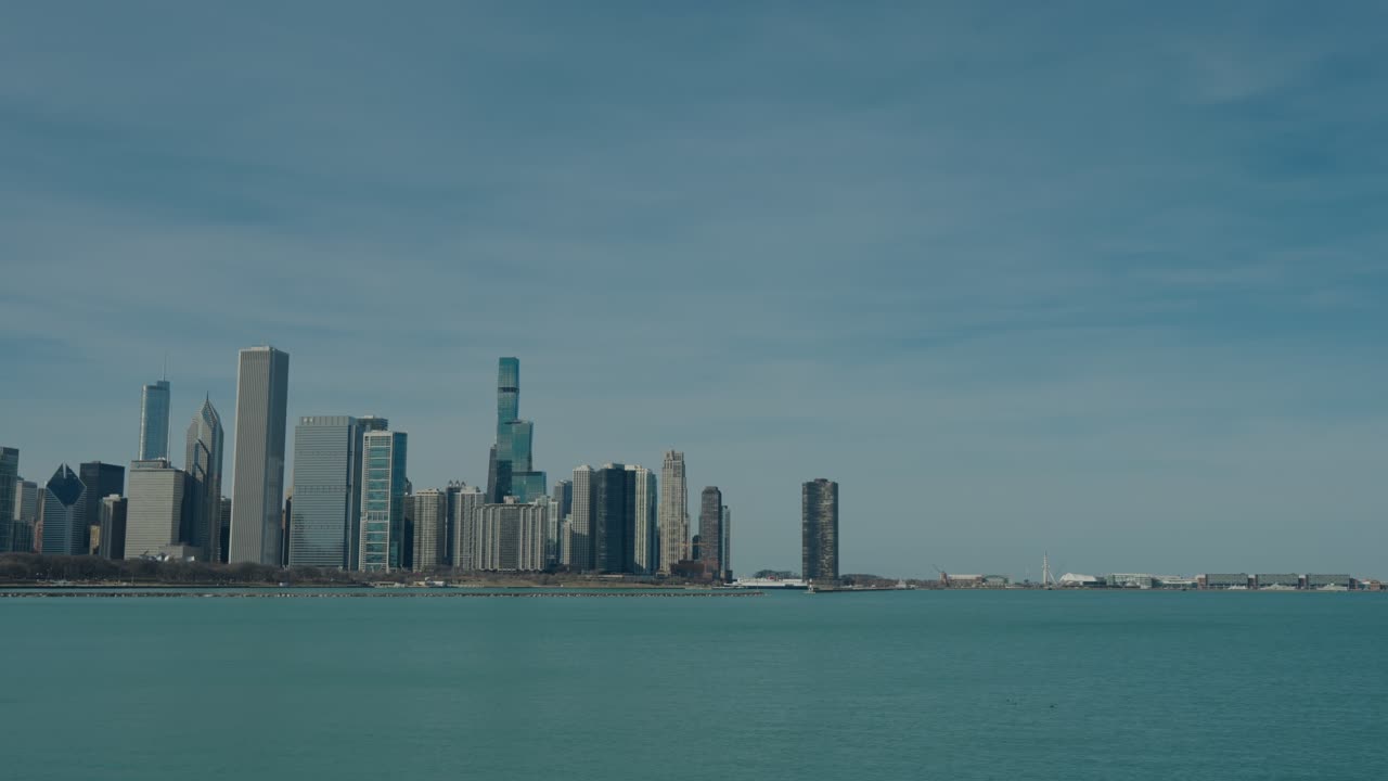 Revealing Chicago's Spectacular Skyline Across Lake Michigan's Teal Waters on Clear Spring Day