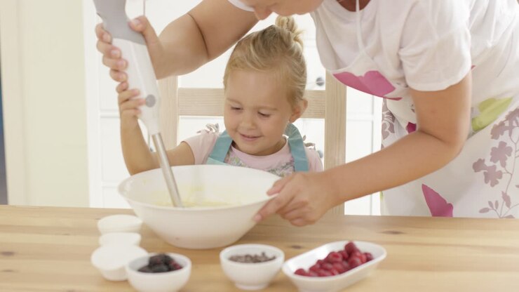 Pretty little blond girl learning to bake