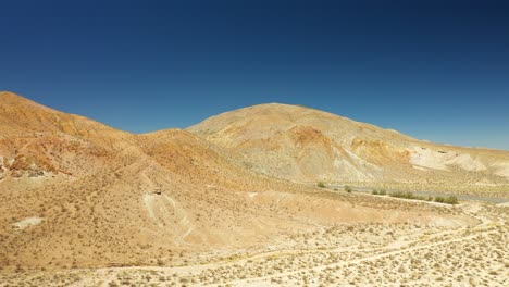 Highway-14-along-Midland-Trail-in-the-Mojave-Desert---aerial-panoramic-parallax-view-of-the-rugged-landscape