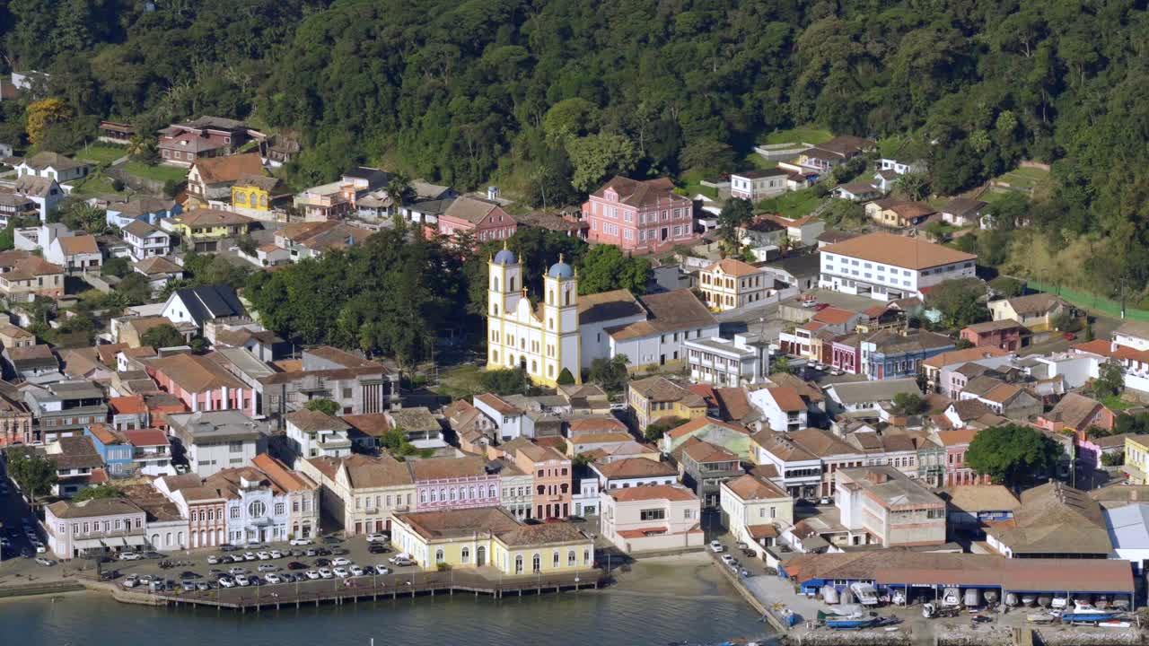 Smooth, lateral drone shot tracks alongside historic buildings, showcasing architectural charm of São Francisco do Sul