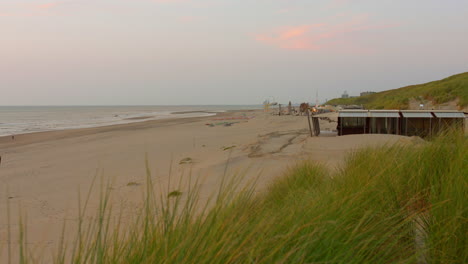 pan shot of beach at sunset during summer in zandvoort, netherlands.