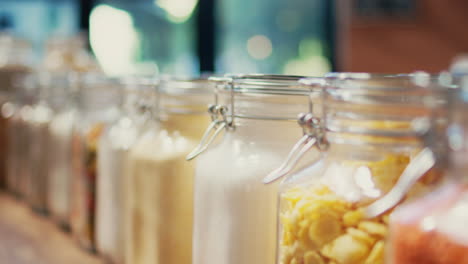 various pasta types and grains stored in reusable jars