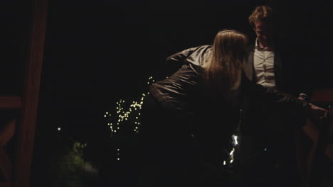 couple celebrating outdoors at night