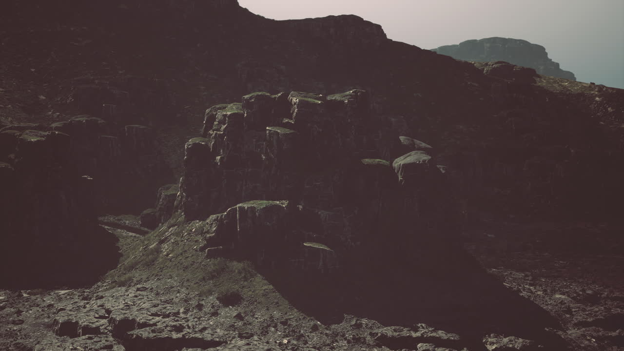 Rocky landscape with rugged cliffs and mountains during overcast weather