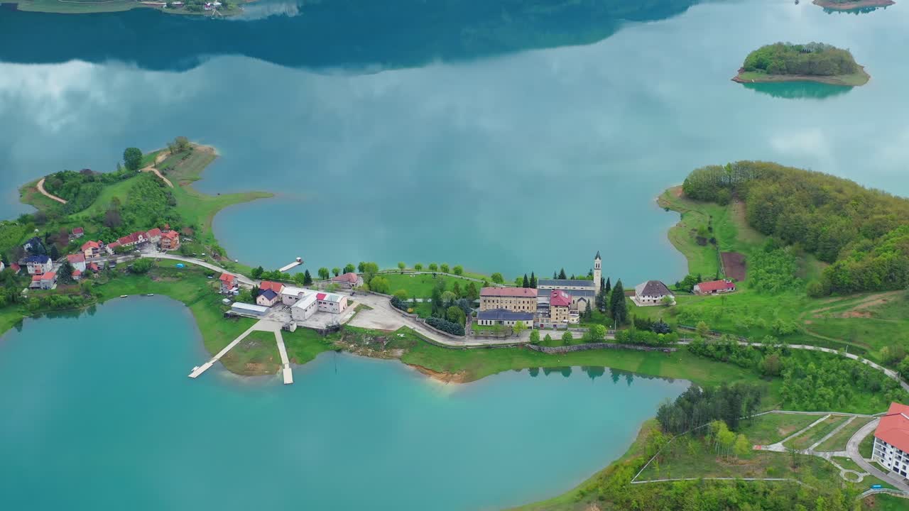 Idyllic Scit Franciscan monastery and Rama lake. Scenic aerial view